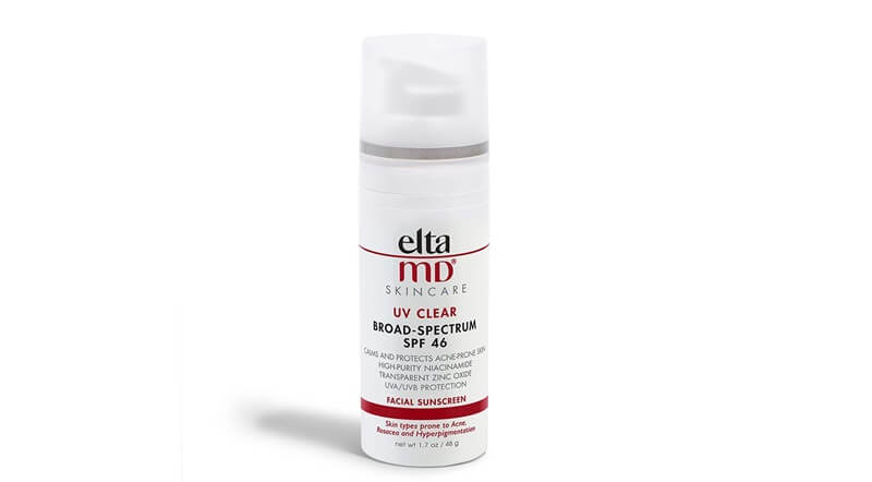 a white and red 48-g pump bottle of the EltaMD UV Clear SPF 46 Face Sunscreen. On the bottle, it says: elta MD, SKINCARE, UV CLEAR, BROAD-SPECTRUM SPF 46, CALMS AND PROTECTS ACNE-PRONE SKIN, HIGH-PURITY NIACINAMIDE, TRANSPARENT ZINC OXIDE, UVA/UVB PROTECTION, FACIAL SUNSCREEN, Skin types prone to Acne, Rosacea and Hyperpigmentation